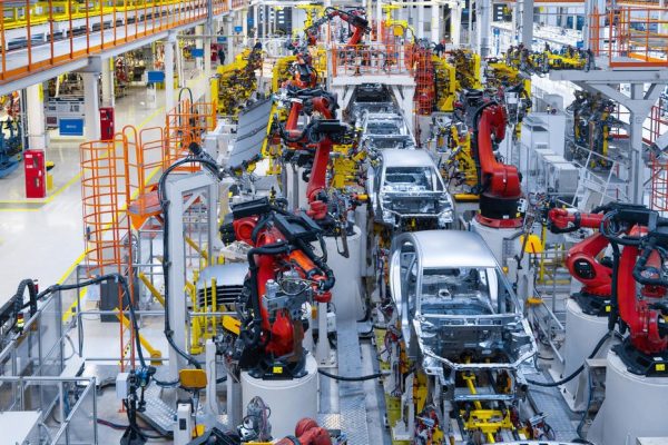 Assembly line production of new car. Automated welding of car body on production line. robotic arm on car production line is working
